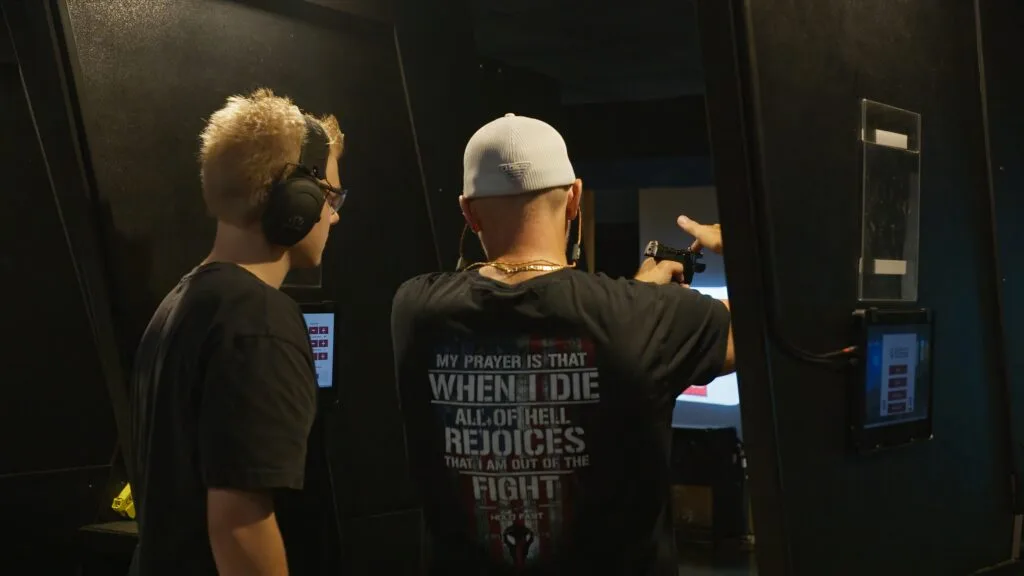An instructor demonstrating proper grip on a handgun.