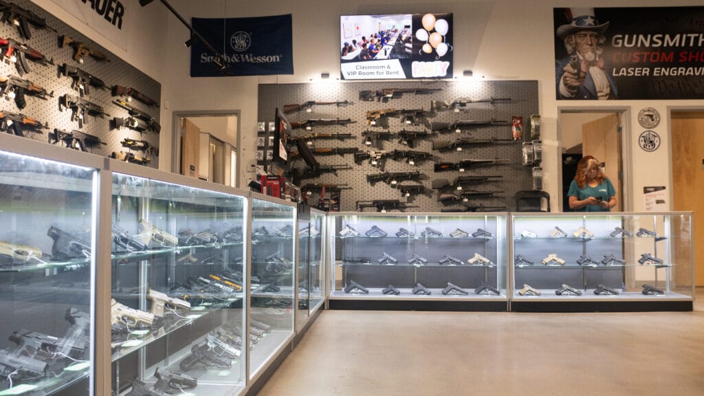 Firearm display cases and gun wall inside the True North Firearm Center at Capitol Range