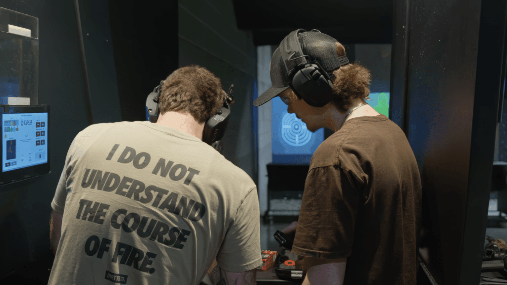 Instructor coaching a concealed carry student during live-fire qualification at Capitol Range