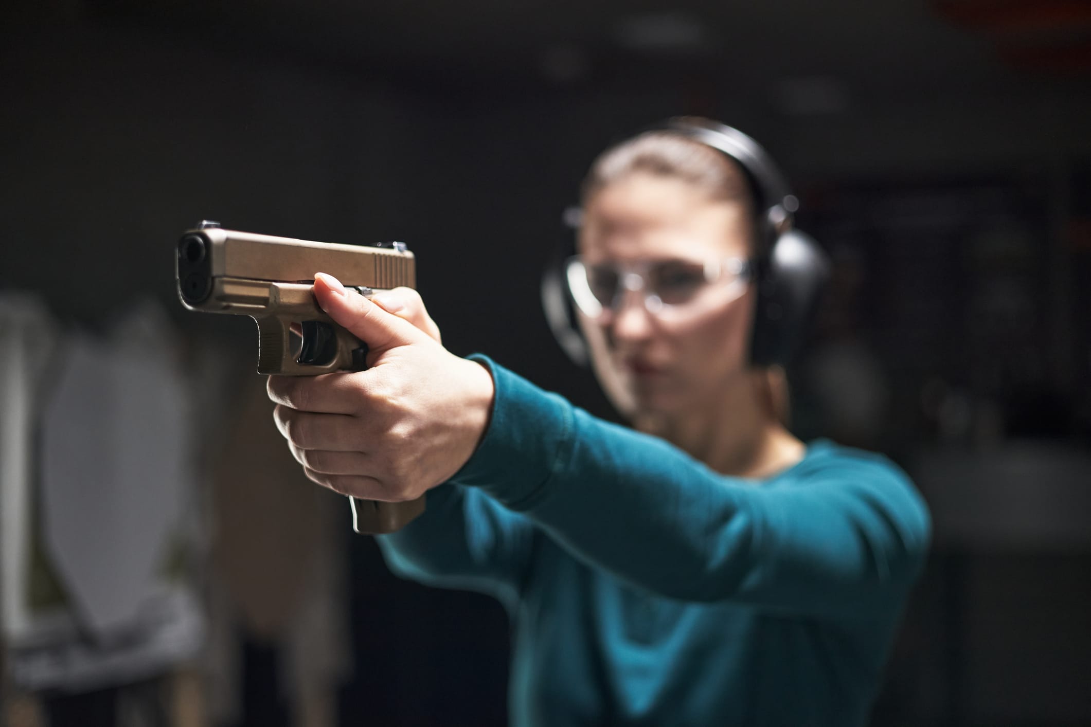 Young Adult Woman Aiming Handgun